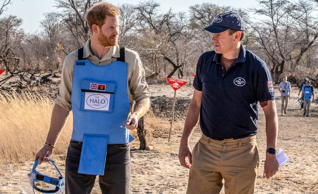 A handout photo made available by the HALO Trust shows Prince Harry (L), Duke of Sussex, visiting the minefield in Dirico, Angola on September 27, 2019. -