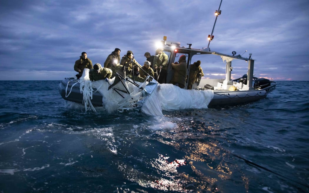 This picture provided by the US Navy shows sailors assigned to Explosive Ordnance Disposal Group 2 recover a high-altitude surveillance balloon off the coast of Myrtle Beach, South Carolina, in the Atlantic ocean on February 5, 2023.