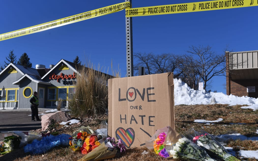 (FILES) Bouquets of flowers and a sign reading "Love Over Hate" are left near Club Q, an LGBTQ nightclub in Colorado Springs, Colorado, on November 20, 2022. A 23-year-old who shot five people dead at an LGBTQ club in the US state of Colorado last year pleaded guilty on June 26, 2023 and will face life in prison. (Photo by Jason Connolly / AFP)