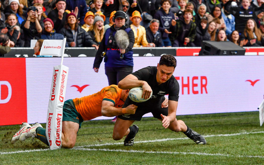 All Black Shaun Stevenson scores in the tackle of Andrew Kellaway during the Bledisloe Cup rugby match at Forsyth Barr Stadium in Dunedin.