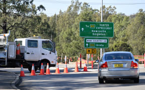 A roadblock some 500 meters from the site of a bus crash, where 10 people from a wedding party were killed, in Cessnock, in Australia's Hunter wine region north of Sydney.