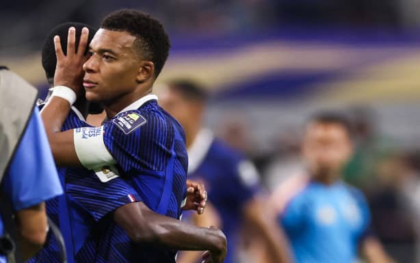 France's forward #10 Kylian Mbappe hugs a teammate after losing the 2026 World Cup football tournament semi-final match between France and Spain at the Dallas Stadium in Arlington on July 14, 2026. (Photo by FRANCK FIFE / AFP)
