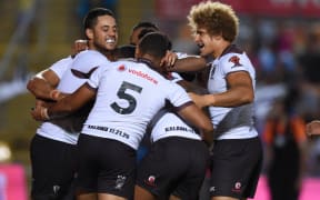 Fiji Bati players celebrate one of the 14 tries scored against Wales