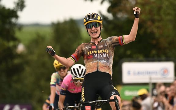 Team Jumbo Visma's Dutch rider Marianne Vos celebrates as she cycles to the finish line to win the 2nd stage of the new edition of the Women's Tour de France cycling race, 2022.