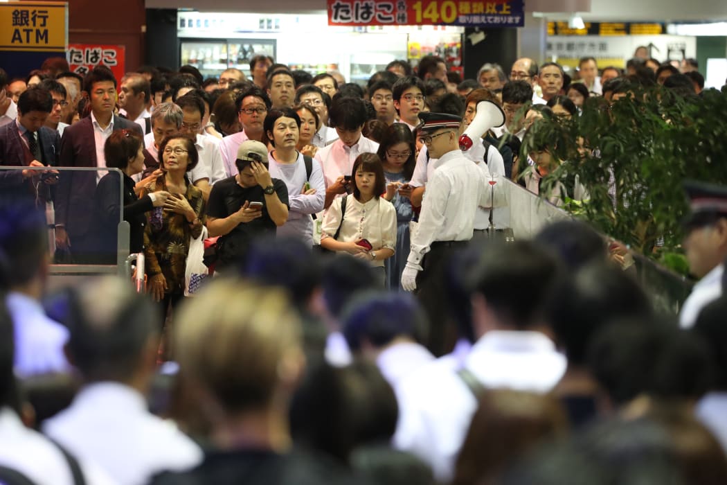 Passengers are stopped before entering the Keio Line Shinjuku Station in Shinjuku,Tokyo.