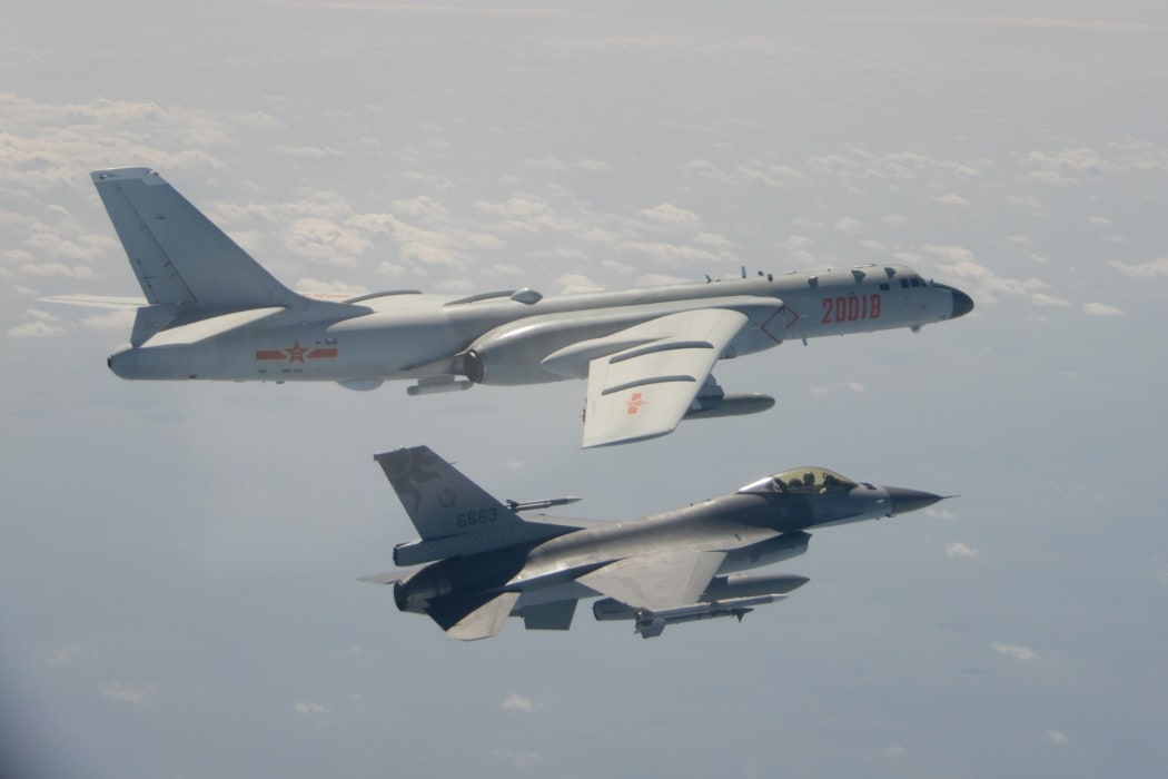 This photo from February shows a Taiwanese F-16 fighter jet flying next to a Chinese H-6 bomber (top) in Taiwan's airspace