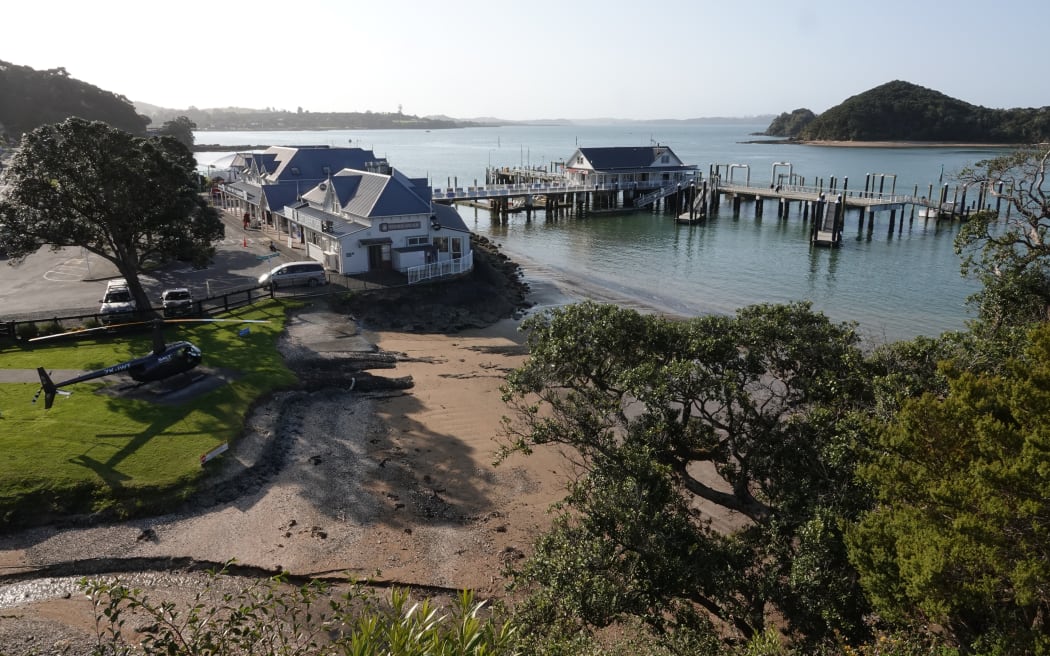 View of Paihia from Maiki/Lookout Hill, with Salt Air helicopter pad, Maritime Building, Paihia wharf and Motumaire Island, Paihia, Bay of Islands.