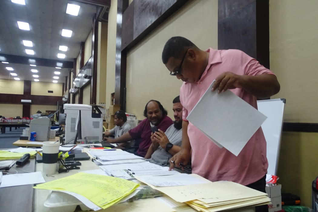 At the Electoral Administration command table Saturday in Majuro working on finalizing all election results, from right: Deputy Election Commissioner Daniel Andrew, election staff Rantly Kattil, Jr. and Bemy Brian, and Chief Electoral Officer Benjamin Kiluwe. Photo: Hilary Hosia.