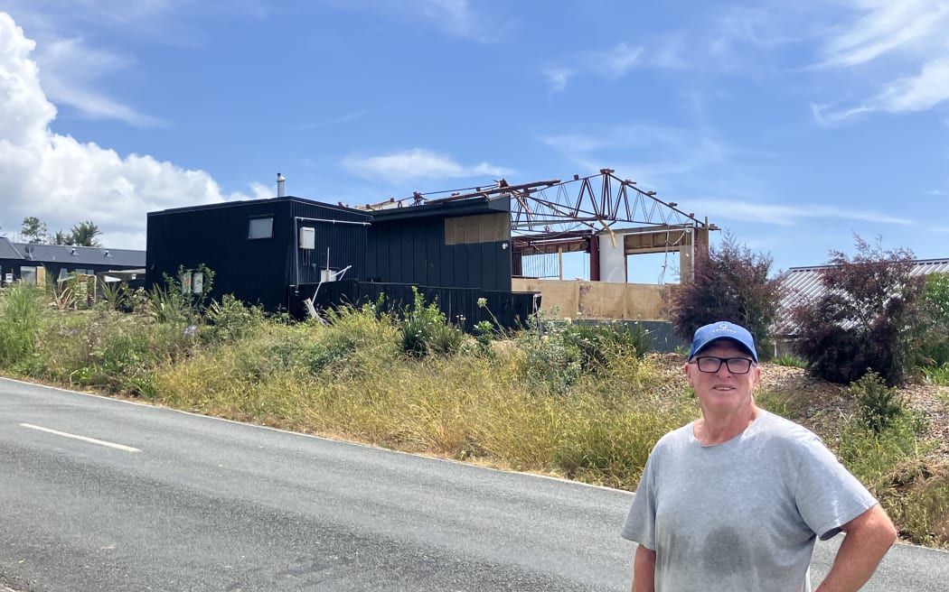 Bruce Howley stands across the road from his barn