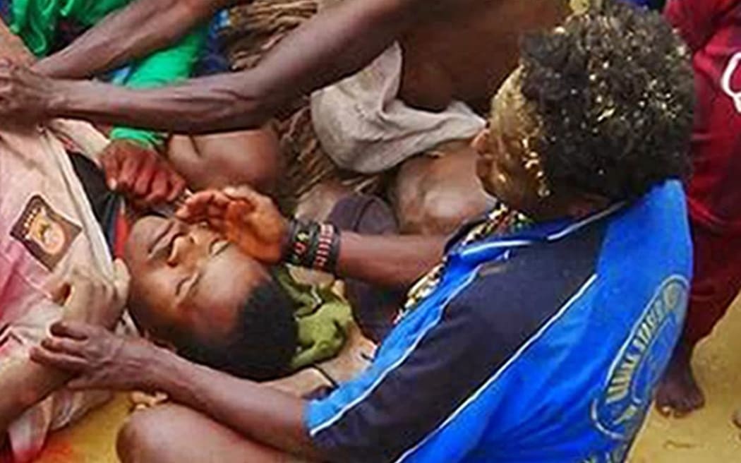 Residents tending to victims after a shooting in Enarotali, Paniai Regency in Indonesia's Papua province. At least four teenagers were shot dead in clashes with security forces, authorities said, although rights campaigners accused police of opening fire on protesters.