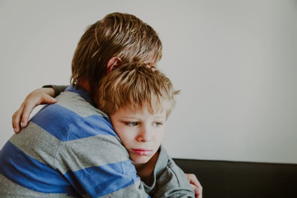 Photo of a father comforting sad child, parenting, sorrow pain