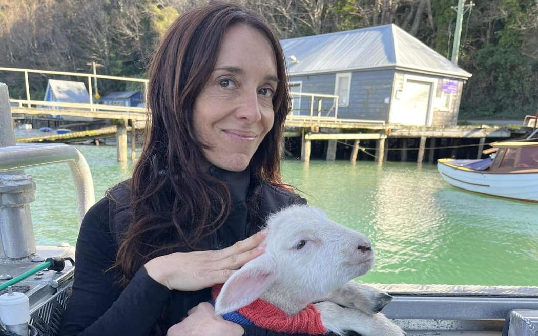 Rachel McGregor, the owner and operator of the Otago Harbour Port to Port ferry with Dave the sheep.
