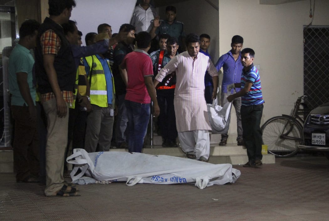 The bodies of two gay rights activists who were hacked to death are brought down from an apartment in Dhaka
