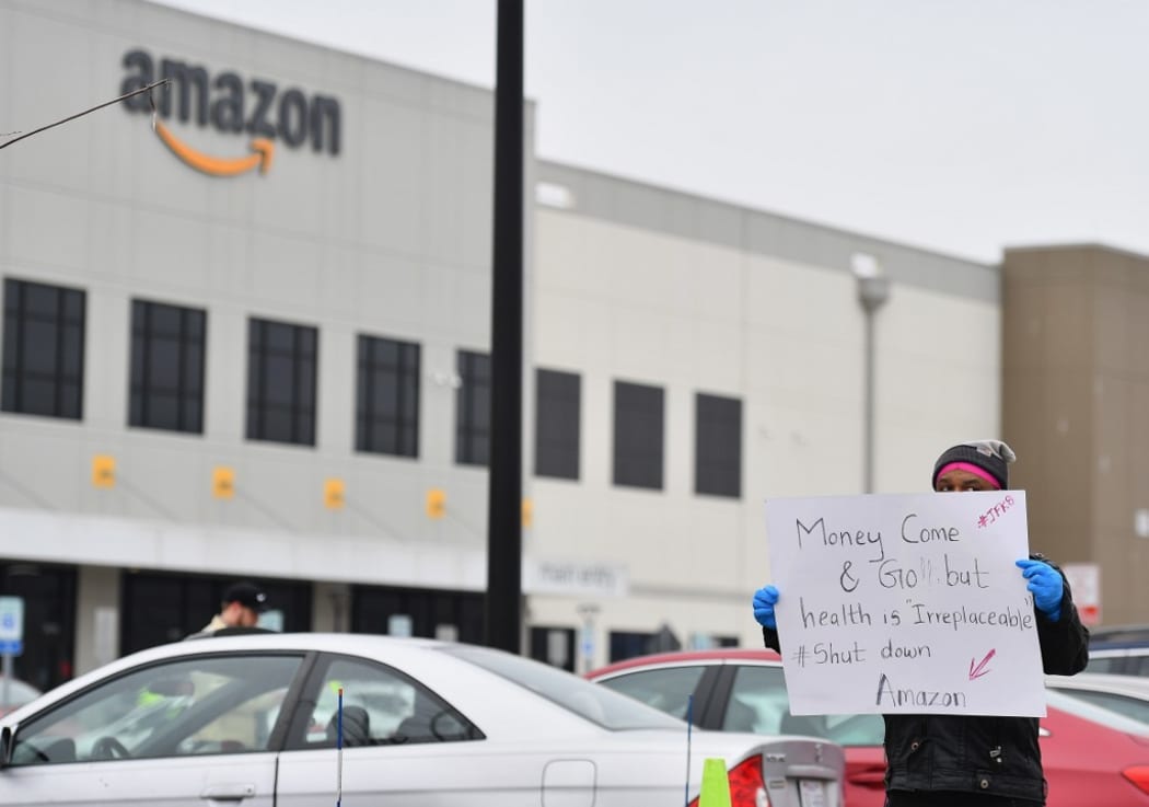 In this file photo taken on March 30, 2020 Amazon workers at Amazon's Staten Island warehouse strike in demand that the facility be shut down and cleaned after one staffer tested positive for the coronavirus in New York.