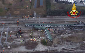 This handout picture released by the Italian Vigili del Fuoco shows firemen working on the site of a train derailment, on January 25, 2018 near Milan.
