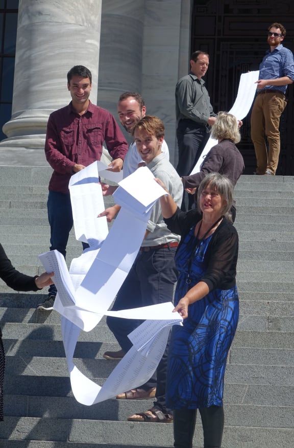 Catherine Delahunty (front) holding part of the list of 12,000 names supporting the call for swimmable freshwater.