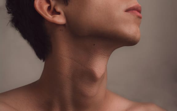 young man with head raised, exposing his bare neck