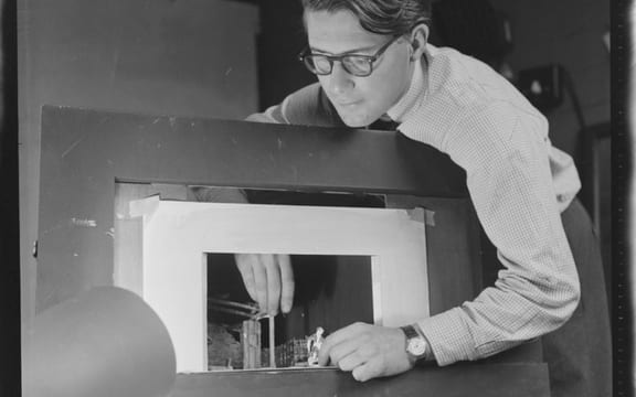 Raymond Boyce, set designer for the New Zealand Players, with a miniature model of a stage and set. Evening post (Newspaper. 1865-2002) :Photographic negatives and prints of the Evening Post newspaper.