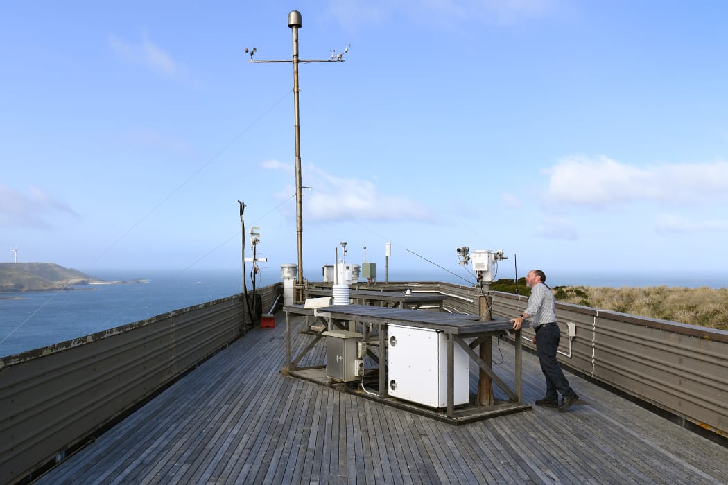 This photo taken on February 25, 2019 show Sam Cleland, the officer in charge of the Cape Grim Baseline Air Pollution Station, looking at the station's equipment in Cape Grim, Tasmania.