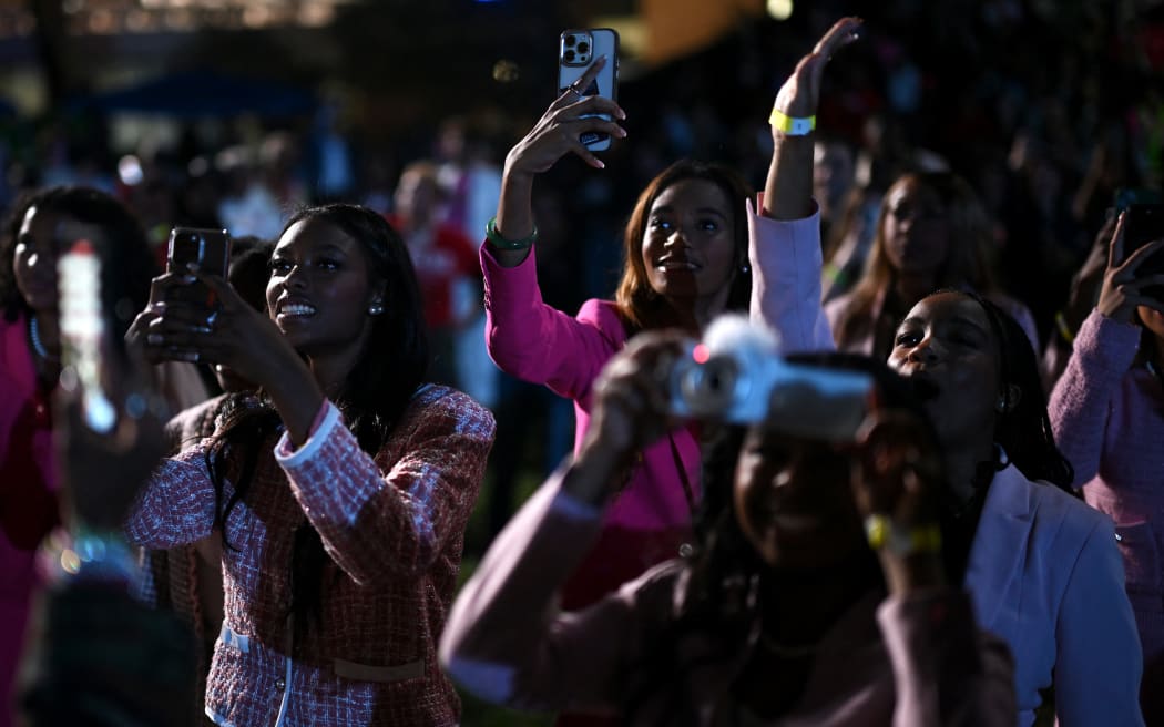 WASHINGTON, DC - NOVEMBER 05: Supporters take pictures as poll results come in as Democratic presidential nominee, U.S. Vice President Kamala Harris holds an election night event at Howard University on November 05, 2024 in Washington, DC. Americans cast their ballots today in the presidential race between Republican nominee former President Donald Trump and Vice President Kamala Harris, as well as multiple state elections that will determine the balance of power in Congress.   Brandon Bell/Getty Images/AFP (Photo by Brandon Bell / GETTY IMAGES NORTH AMERICA / Getty Images via AFP)