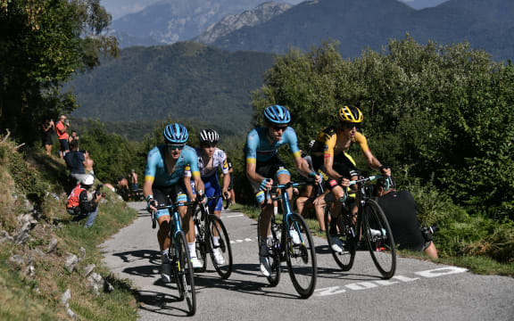 Astana Pro Team Denmark rider Jakob Fuglsang (L) climbs flanked by Team Jumbo-Visma New Zealand rider George Bennett (R) during the 114th edition of the giro di Lombardia (Tour of Lombardy),  a 231 km cycling race from Bergamo to Como on August 15, 2020. (Photo by Marco Bertorello / AFP)
