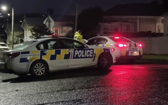 A police officer at a cordon on the corner of Murdoch Road and Dickens Street, Grey Lynn, on Tuesday 19 July 2022. Police had shot and critically injured a man who they say pointed a gun at officers on Wallingford St on Monday evening.