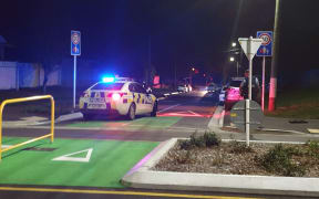Armed police blocking Sheldon Street in Woolston, Christchurch.