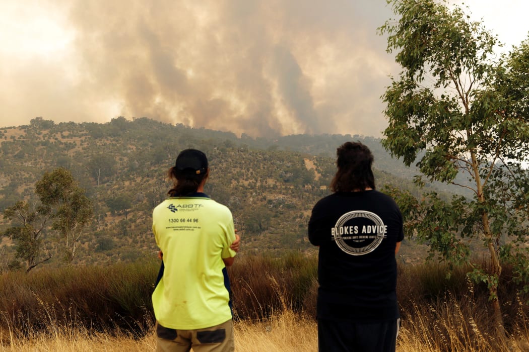 People watch as a fire burns in Perth