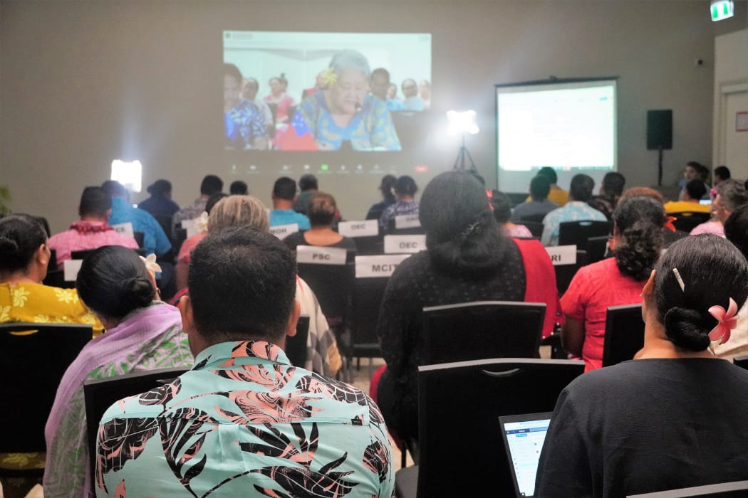 Samoans take note of a video link with the Chief Executive Officer of Samoa's Ministry of Foreign Affairs and Trade, 
Peseta Noumea Simi, discussing the country's Universal Periodic Review at the UN Human Rights Council.