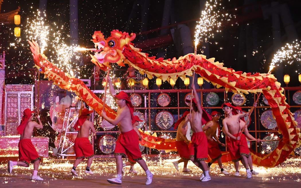 Dragon dancers perform at a park on the first day of the Lunar New Year of the Dragon in Beijing on February 10, 2024. (Photo by GREG BAKER / AFP)