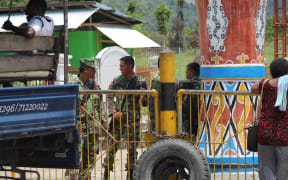 Indonesian soldiers man the border with Papua New Guinea at Wutung.