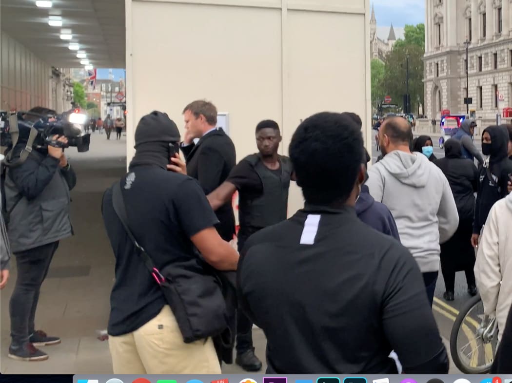 The crowd to move around Channel 9 crew and began to surge forward as security tries to keep them back.