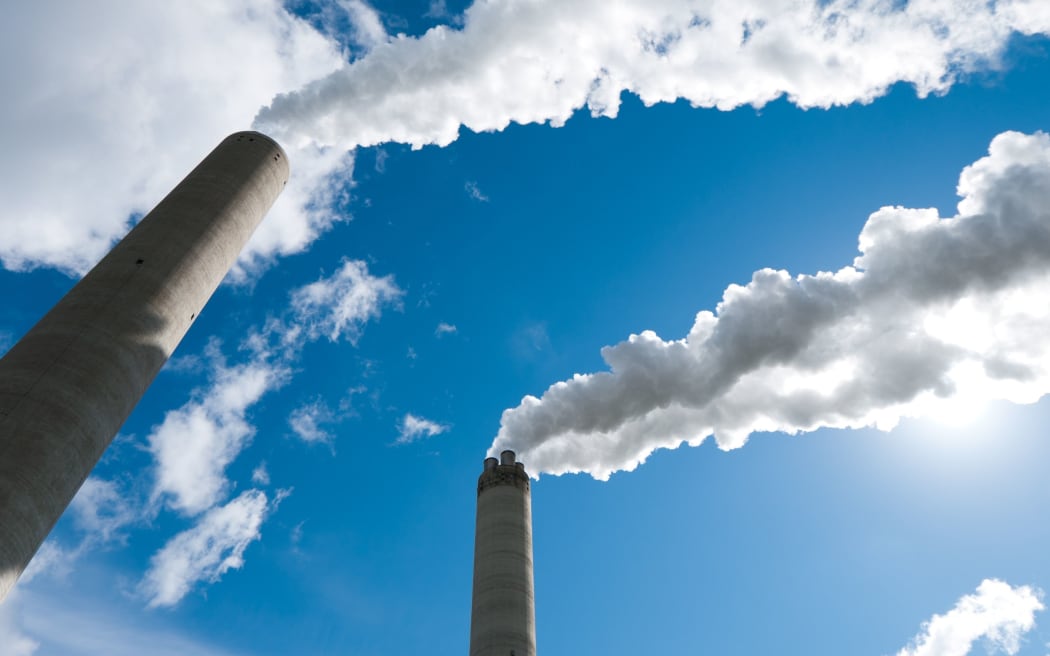 14596413 - smoking industrial chimneys against a blue sky