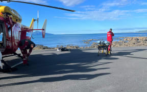 The Westpac Rescue Helicopter on Kāpiti Coast waiting to take the man to hospital.