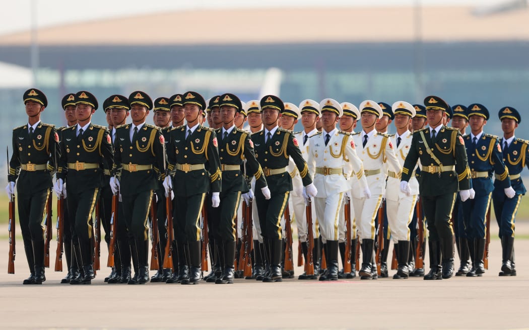 Honour guards stand as Serbian President Aleksandar Vucic (not pictured) arrives at the Beijing Capital International airport on September 2, 2025, to attend a military parade commemorating the 80th anniversary of the end of World War II and Japan's surrender. (Photo by Lintao Zhang / POOL / AFP)