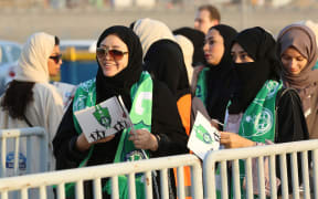 Female Saudi supporters of Al-Ahli queue at an entrance for families and women at the King Abdullah Sports City