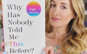 Dr Julie Smith holds a copy of her book 'Why has nobody told me this before?'
