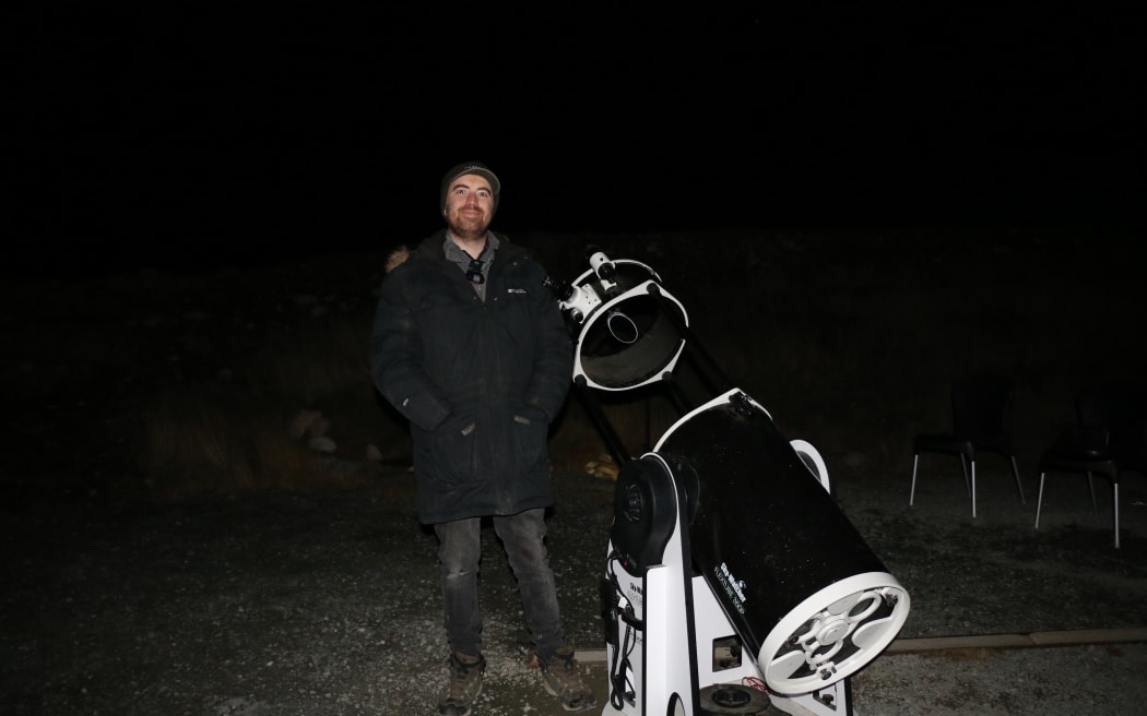 Tour guide and business manager Sam Blair with a Dobsonian telescope.