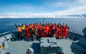 Crew on the 2021 Antarctic voyage take a team photo off Daniell Peninsula.