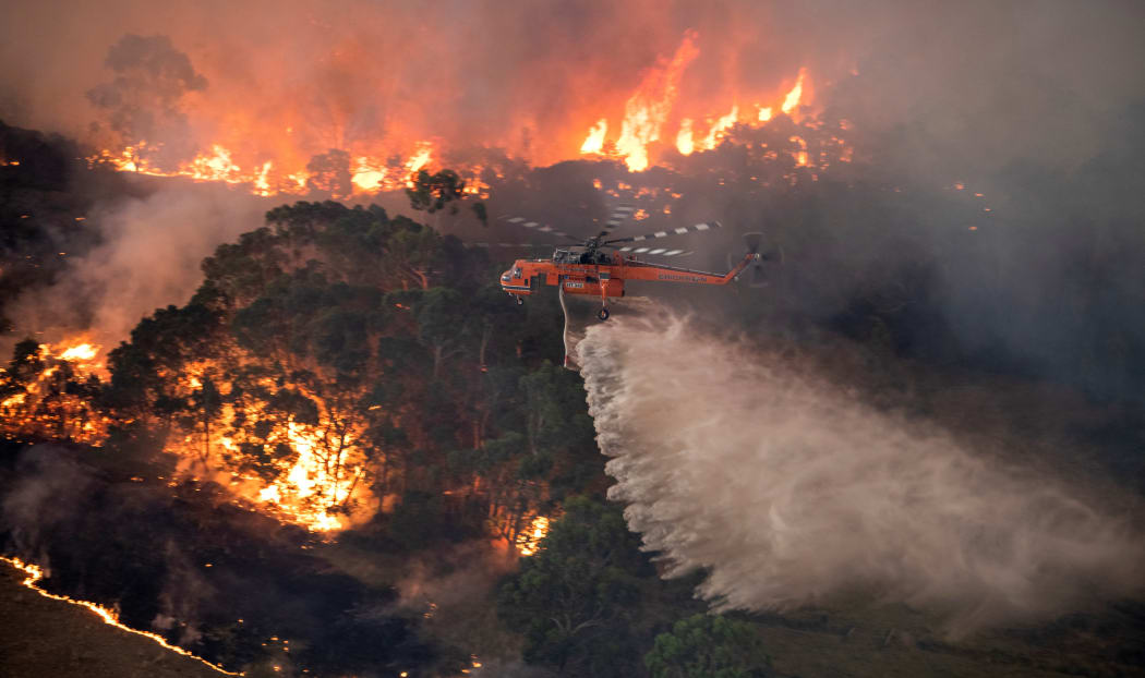 A helicopter fighting a bushfire near Bairnsdale in Victoria's East Gippsland region on 31 December, 2019.