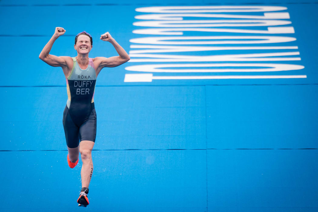 Bermuda's Flora Duffy celebrates as she crosses the finish line to win the women's individual triathlon competition during the Tokyo 2020 Olympic Games on 27 July, 2021.