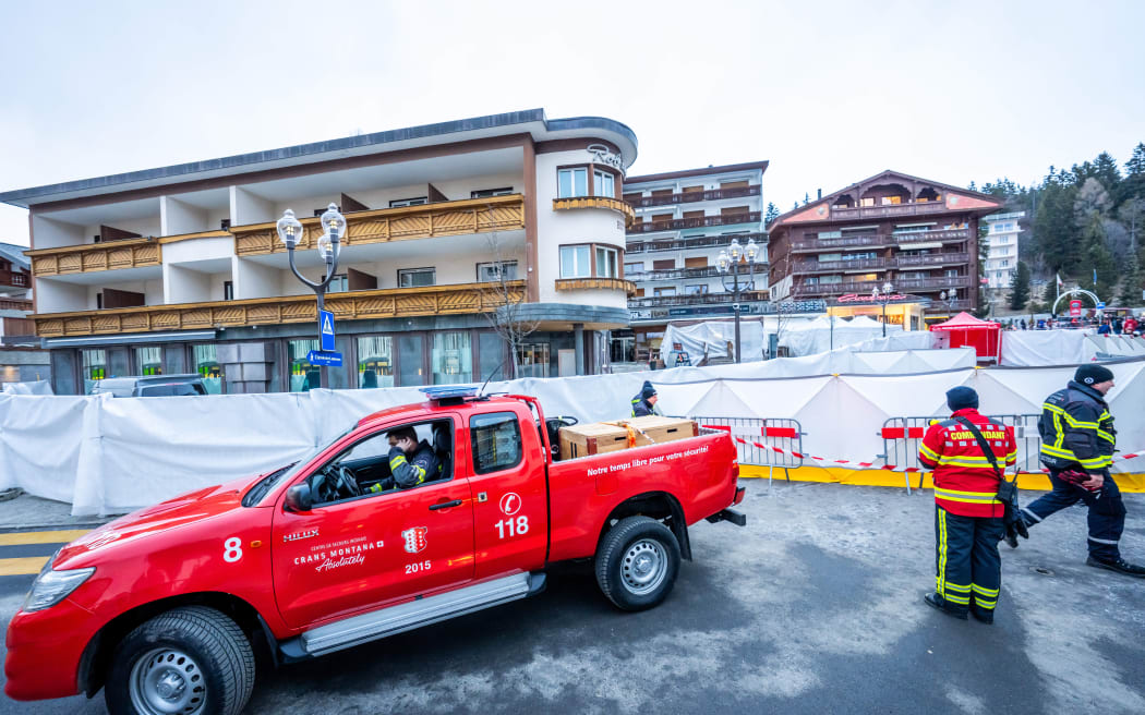 Firefighters exit the Constellation bar where a fire ripped through during New Year's Eve celebrations in the Alpine ski resort town of Crans-Montana killing around 40 people and injuring more than 100 others, in Crans-Montana on January 2, 2026.