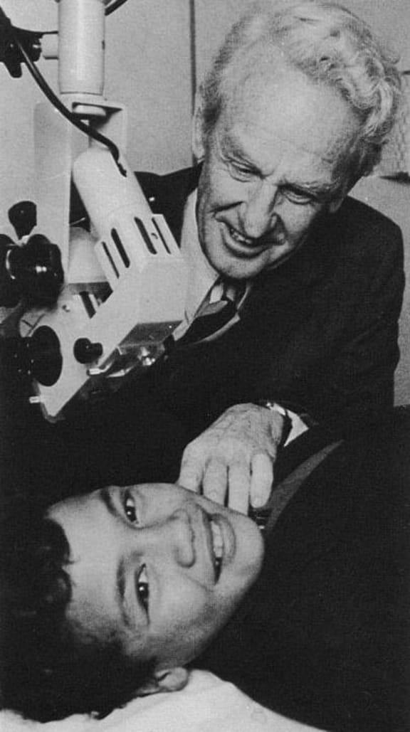 Sir Patrick Eisdell Moore with a young patient in the 1960s.