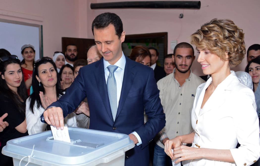 President Bashar al-Assad and wife Asma al-Assad casting their votes at a polling station in Maliki.