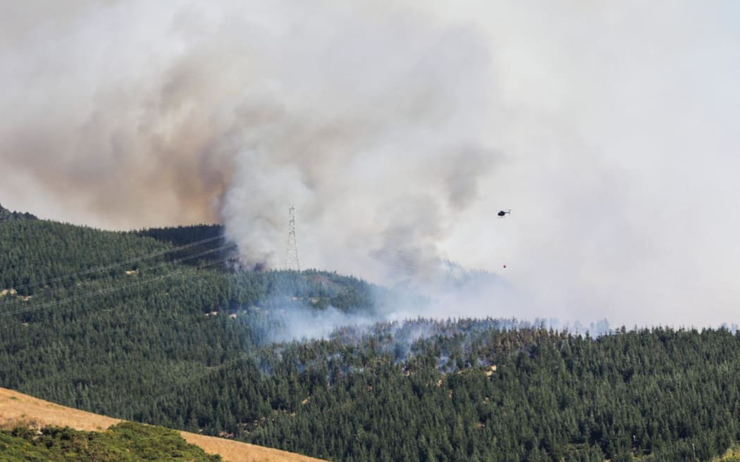 Helicopters swoop in to fight the blaze, as seen from Worsleys Road.