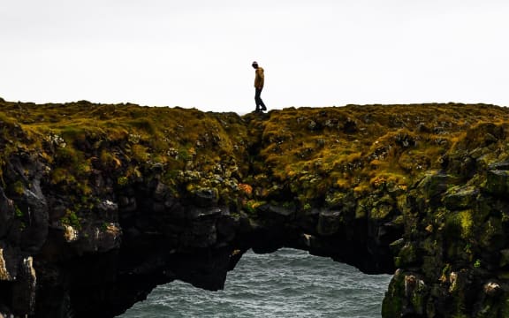 person walking alone over ocean