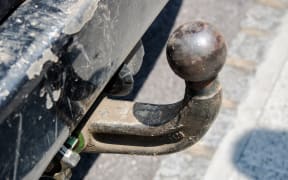 Old ball car hook conected to rusty chassis close up view