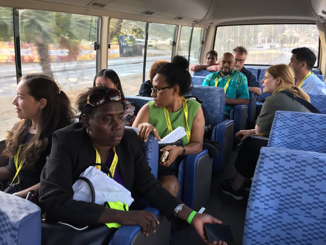 International and local journalists on a bus back to town after Chinese officials denied them permission to attend an APEC event featuring China's president.
