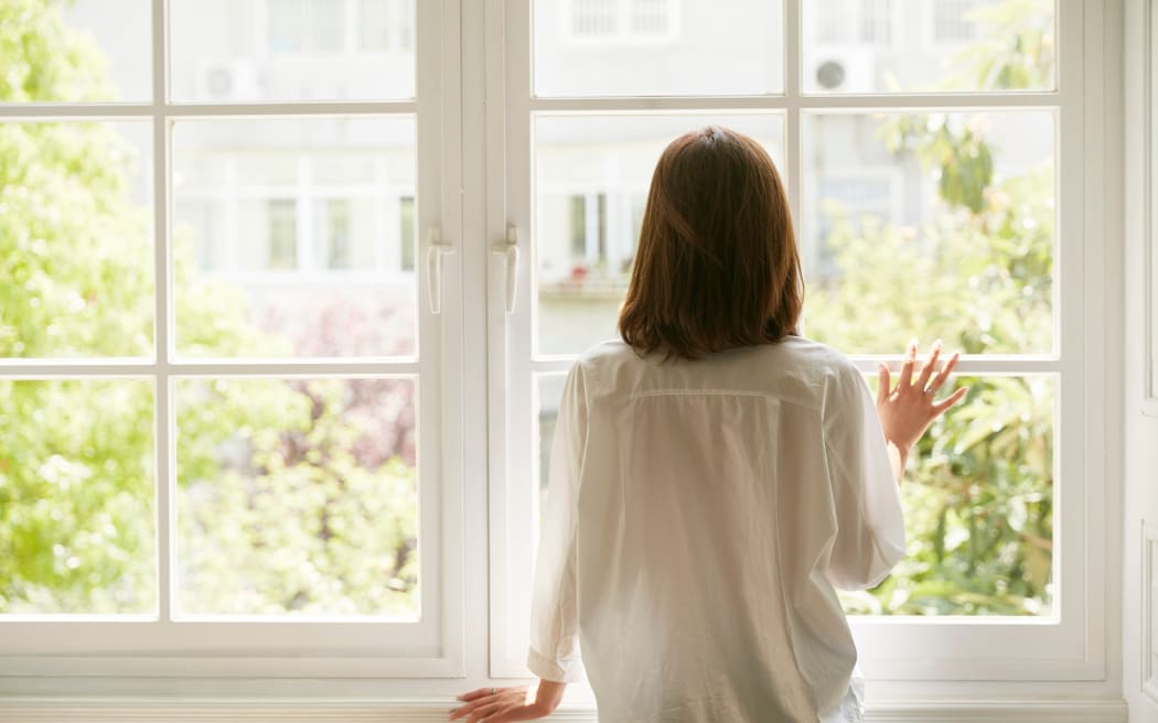 Woman looking out window