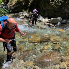 Tim Pankhurst helps Kerry Prendergast across a river